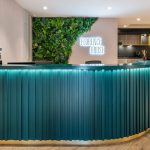 Why Neon Signs & Green Walls Make the Perfect Business Logo Combo